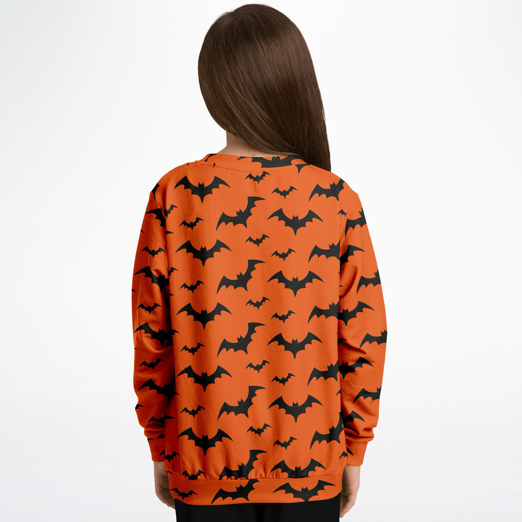 Kids orange long-sleeved sweatshirt with black bat patterns made of cozy cotton fleece for halloween use