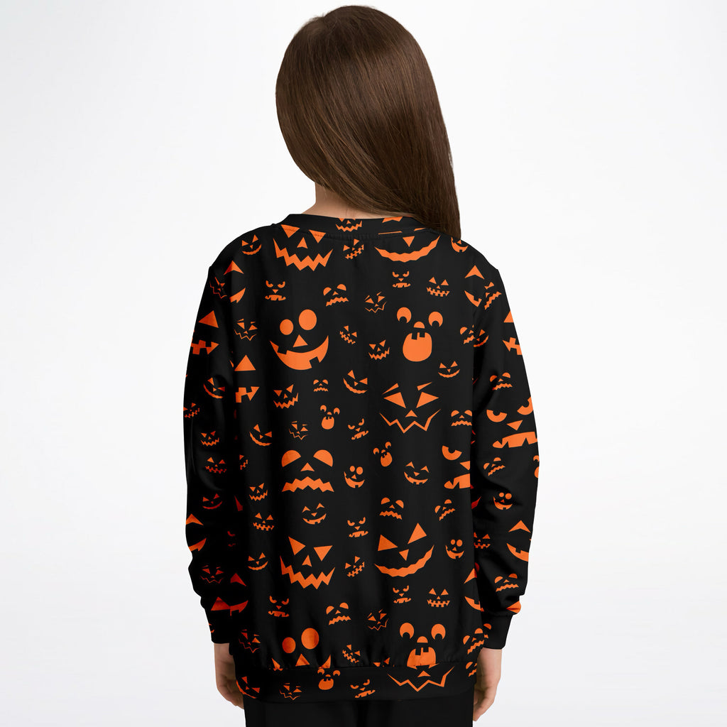 Kids black long-sleeved jack-o-lantern sweatshirt with vibrant orange pumpkin face in cozy cotton fleece