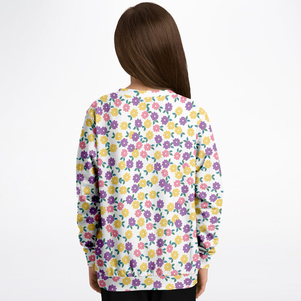 A white girls sweatshirt with colorful purple yellow and pink floral pattern in cozy cotton fleece fabric