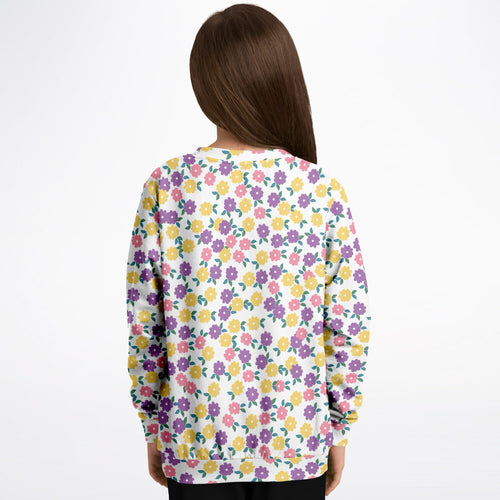A white girls sweatshirt with colorful purple yellow and pink floral pattern in cozy cotton fleece fabric