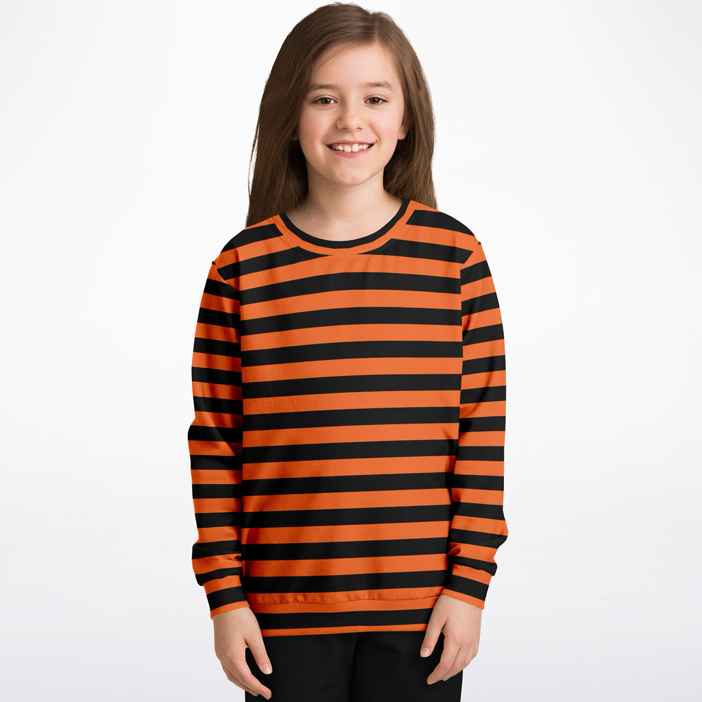 A child wearing a kids orange and black striped Halloween sweatshirt made of cozy cotton fleece or lightweight fabric