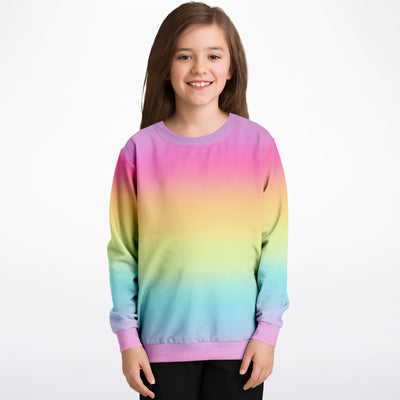 Girls bright rainbow sweatshirt with vibrant gradient, soft cotton fleece fabric, and pastel pink ribbed cuffs