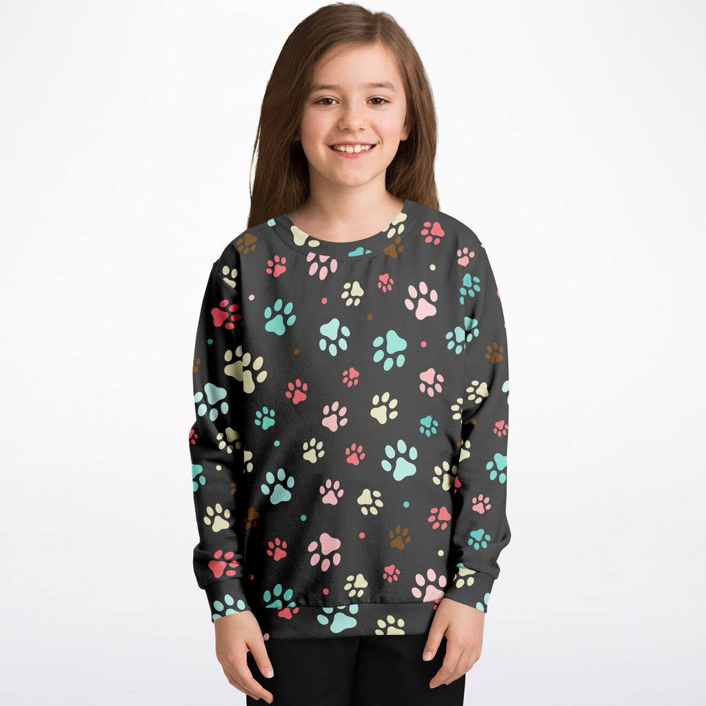Black kids sweatshirt with colorful pink teal and beige paw prints made of cozy cotton fleece or lightweight sports fabric