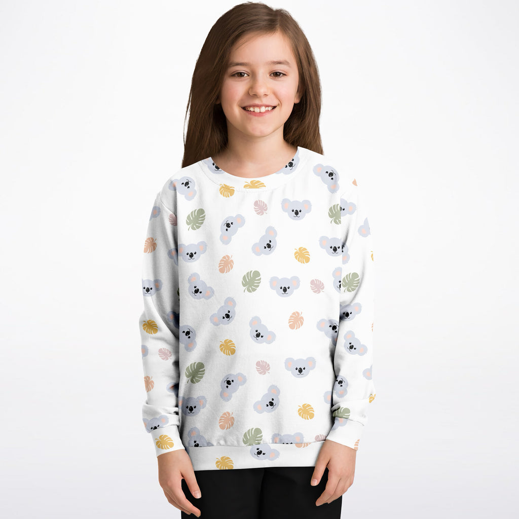 White kids sweatshirt with gray koala and pastel tropical leaf pattern made of cozy cotton fleece or lightweight fabric
