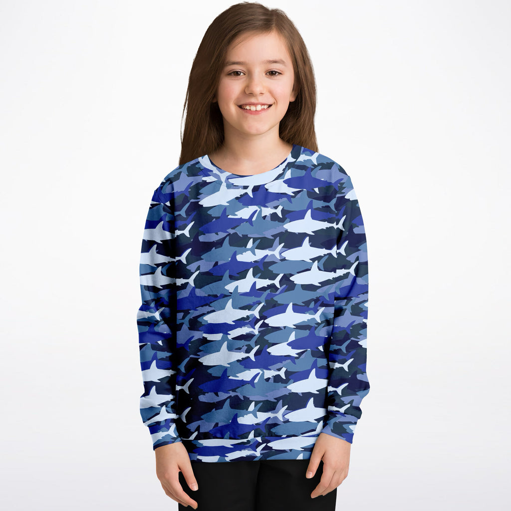 A child wearing a kids blue shark sweatshirt with shark camouflage in cozy cotton fleece fabric