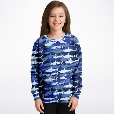 A child wearing a kids blue shark sweatshirt with shark camouflage in cozy cotton fleece fabric