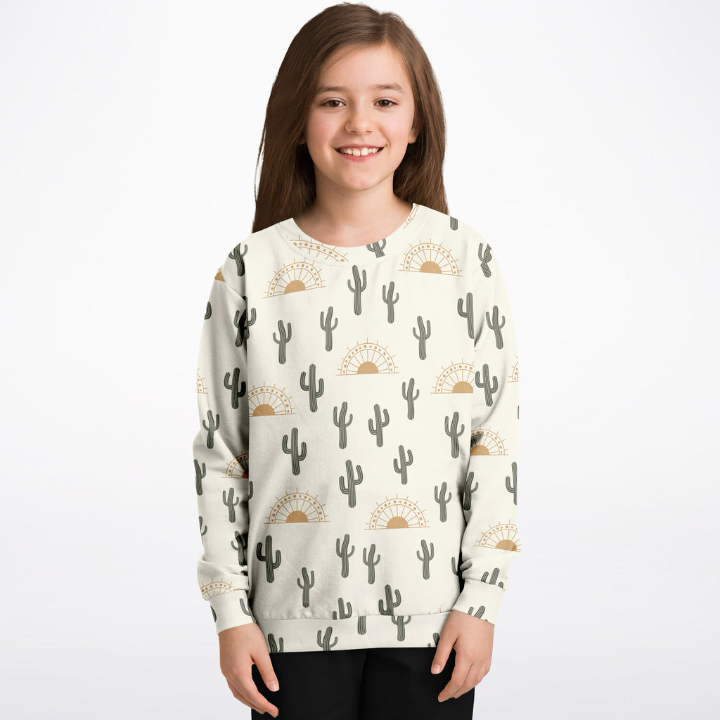 Kids cream-colored sweatshirt with gray cactus and gold sunburst pattern made of cozy cotton fleece or lightweight fabric