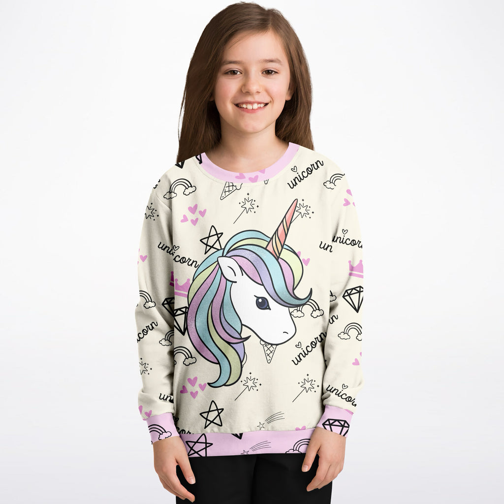 A cream-colored girls magical unicorn sweatshirt with a rainbow unicorn graphic and cotton fleece fabric
