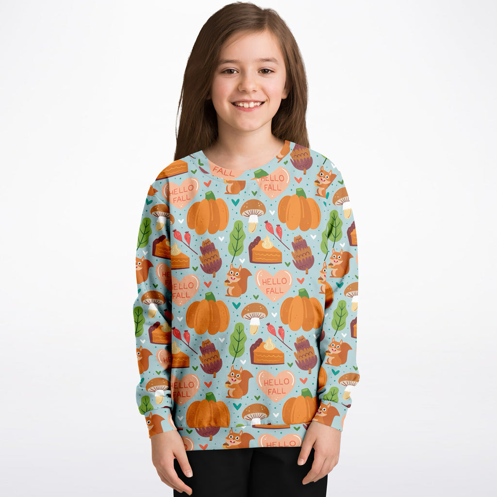 A child wearing a light blue kids hello fall autumn themed sweatshirt with pumpkins squirrels and mushrooms in cotton fleece