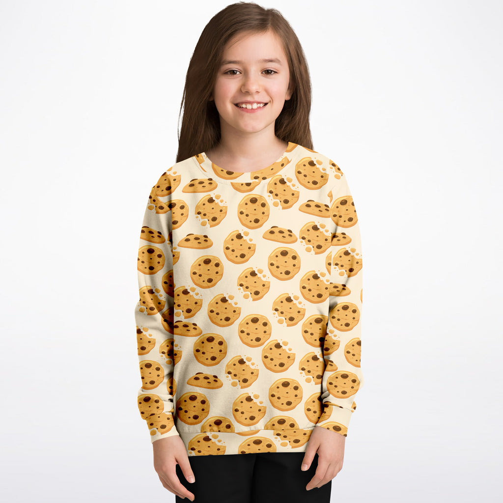 Cream-colored kids sweatshirt with playful golden-brown chocolate chip cookie print made from cozy cotton fleece