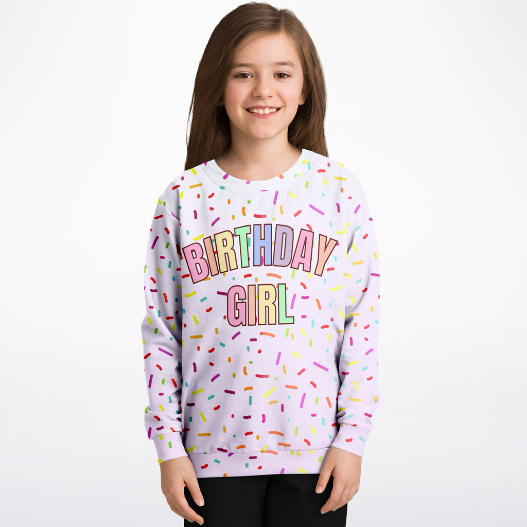 A soft lavender birthday girl sweatshirt with colorful rainbow sprinkles made from cozy cotton fleece or lightweight sports fabric