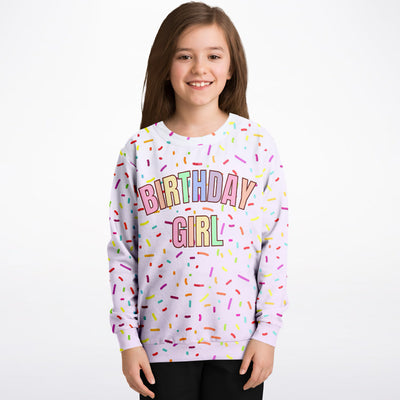 A soft lavender birthday girl sweatshirt with colorful rainbow sprinkles made from cozy cotton fleece or lightweight sports fabric