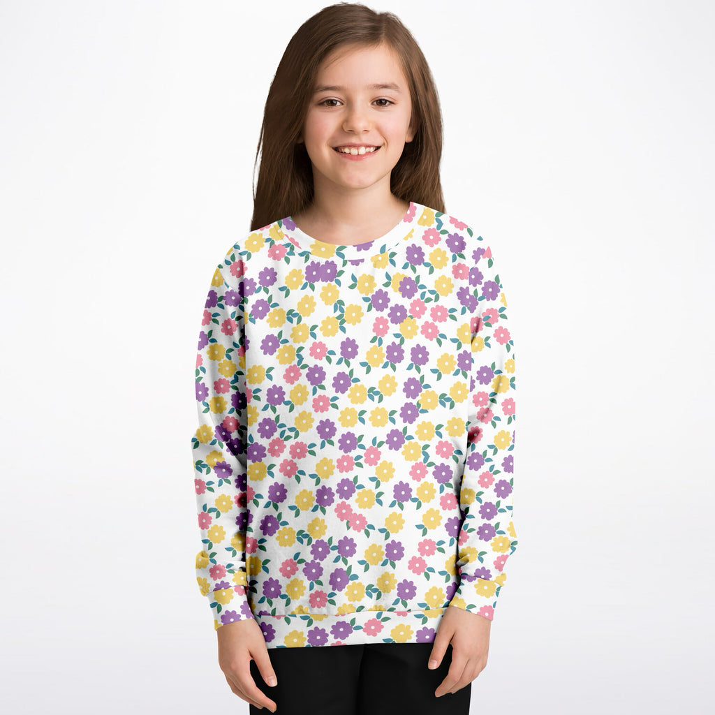 A white girls long-sleeved sweatshirt with colorful pink purple and yellow floral pattern in cozy cotton fleece