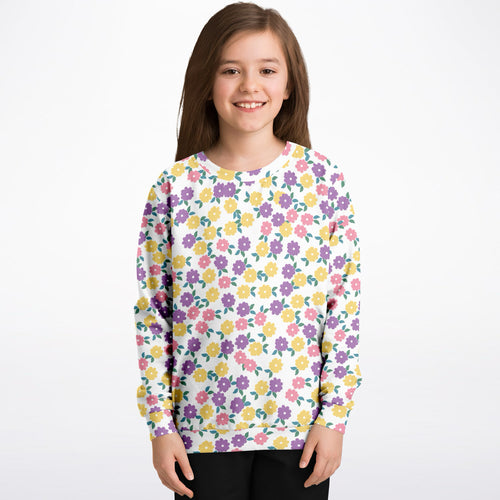 A white girls long-sleeved sweatshirt with colorful pink purple and yellow floral pattern in cozy cotton fleece