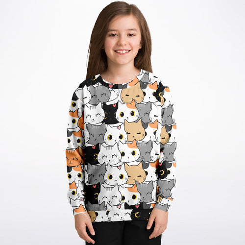 Girl wearing a sweater with cat pattern on a white background