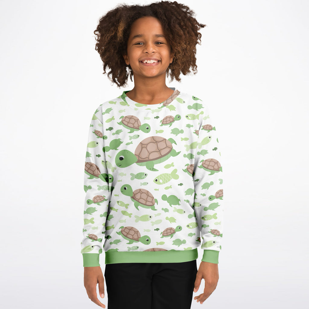 Kids white cotton fleece sweatshirt with green and brown turtles and fish pattern and light green ribbed cuffs and hem