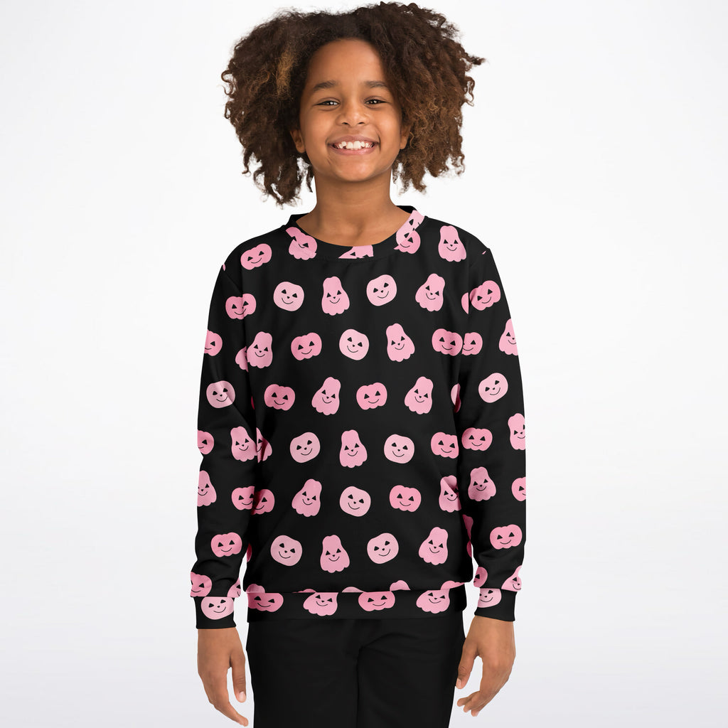 Black girls sweatshirt with pink cartoon pumpkin faces printed all over in cozy cotton fleece for halloween