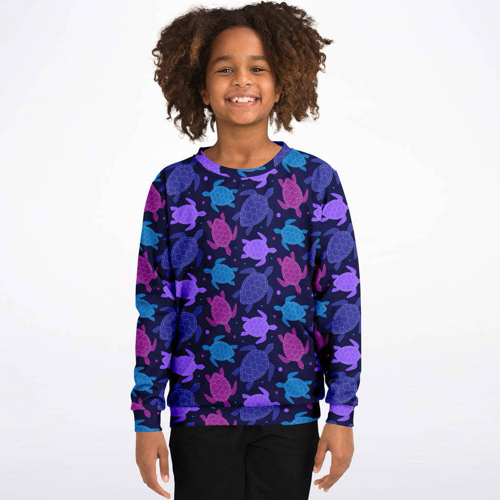 A child wearing a girls purple sea turtle sweatshirt in cozy cotton fleece with vibrant sea turtle pattern