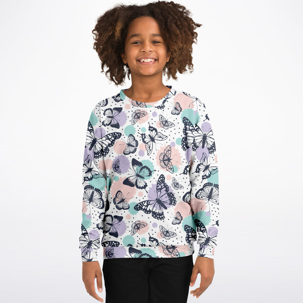 A child wearing a girls butterfly sweatshirt with black lavender and mint cotton fleece in a playful pattern on white