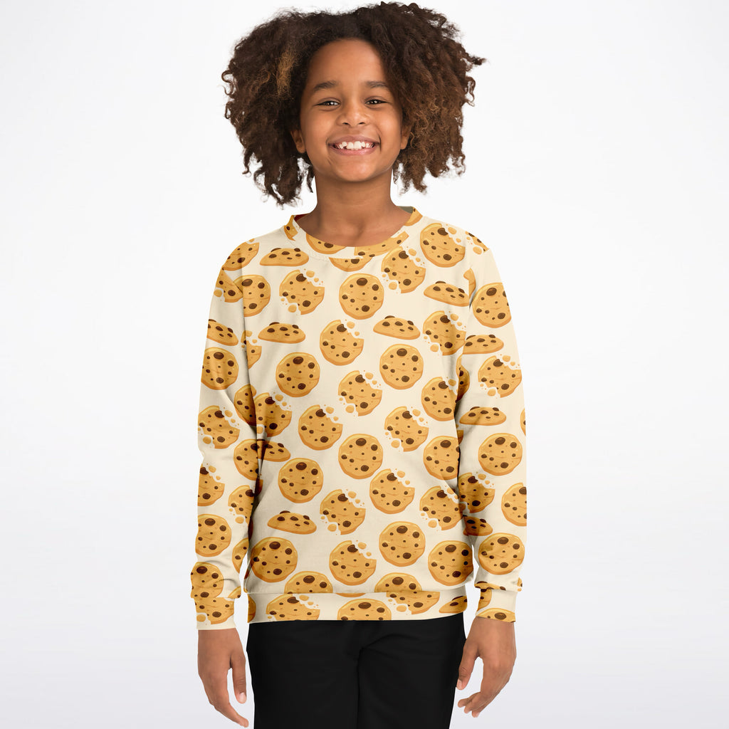 Cream-colored kids sweatshirt with playful golden-brown chocolate chip cookie print in cozy cotton fleece fabric