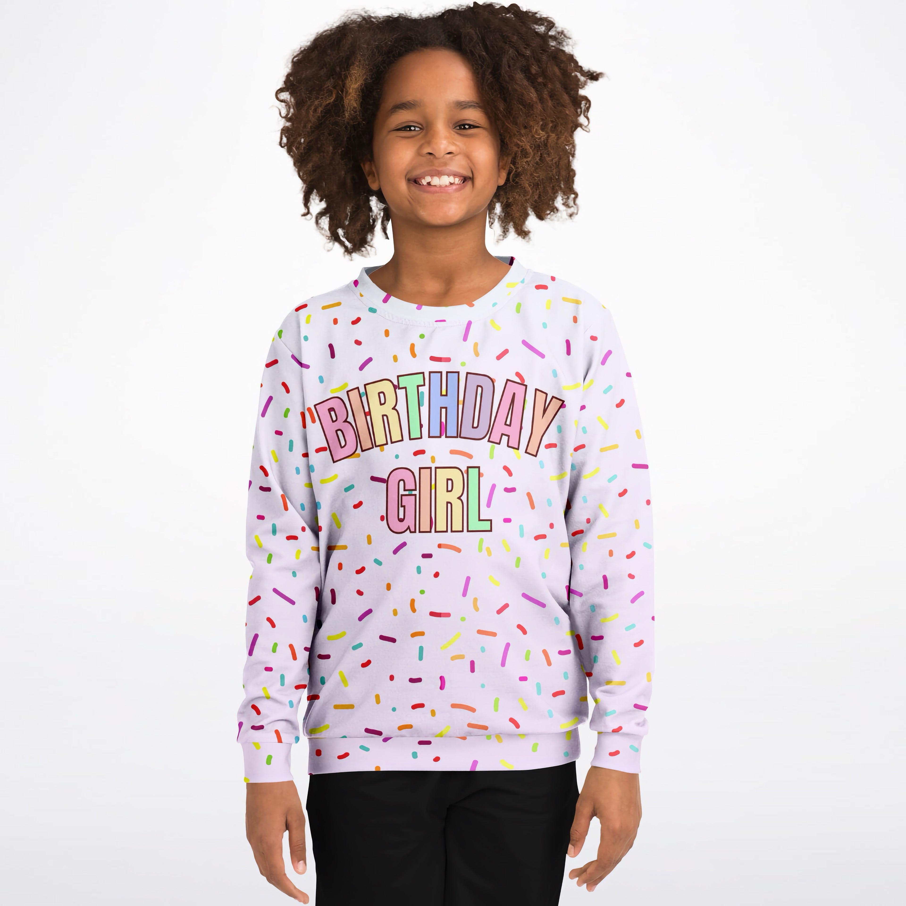 A soft lavender sweatshirt with colorful birthday girl lettering and playful rainbow sprinkles made of cozy cotton fleece