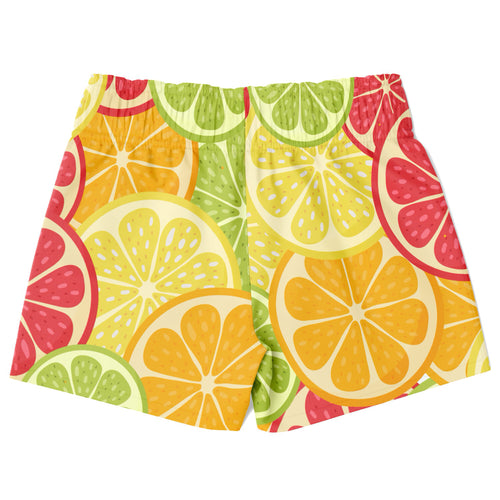 Boys citrus fruit quick drying swim trunks in bright orange yellow green and pink with sliced citrus pattern