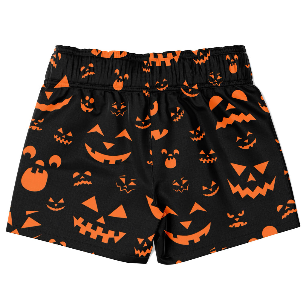 Boys black quick drying swim trunks with vibrant orange jack-o-lantern faces for Halloween