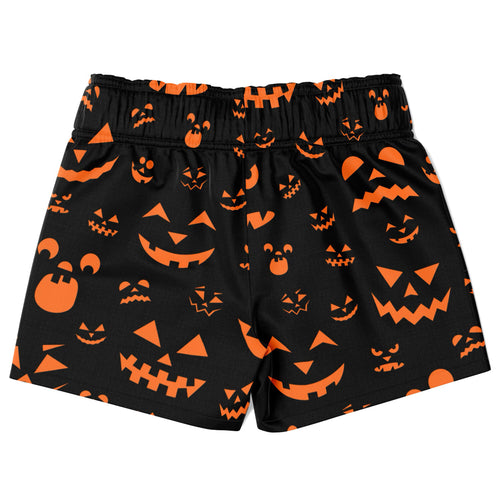 Boys black quick drying swim trunks with vibrant orange jack-o-lantern faces for Halloween