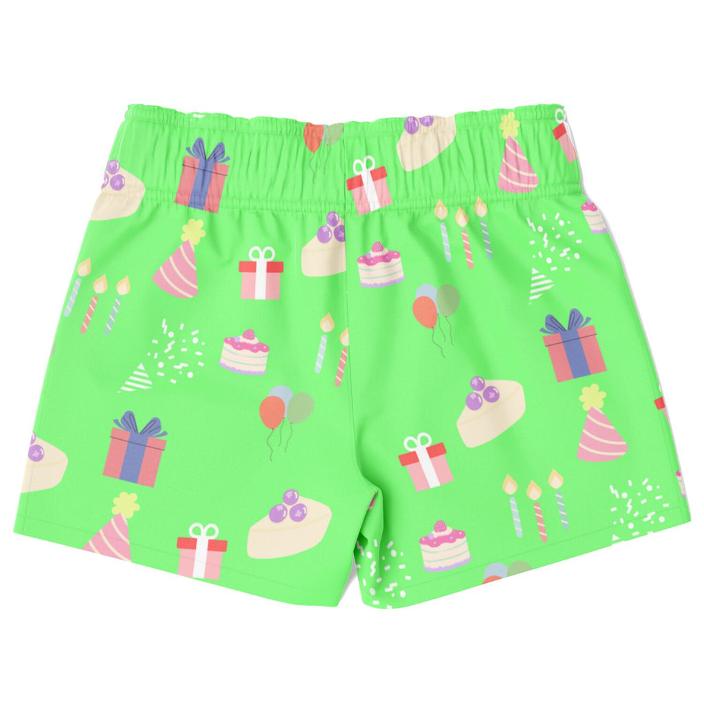 Green shorts with birthday cake and gift pattern on a white background