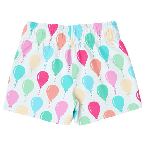 White boys swim trunks with colorful pink teal coral and mint balloon pattern quick drying fabric