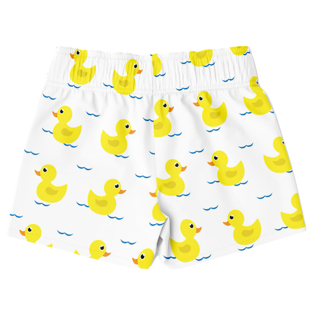 Boys white quick drying swim trunks with a playful yellow rubber duck pattern floating on blue water
