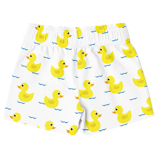 Boys white quick drying swim trunks with a playful yellow rubber duck pattern floating on blue water