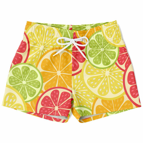 Boys citrus fruit quick drying swim trunks with vibrant lime green yellow and pink citrus pattern on cream background