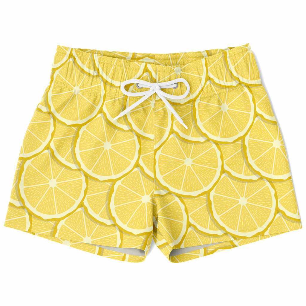 Boys lemon slice quick drying swim trunks in bright yellow with white drawstrings and a sliced lemon pattern