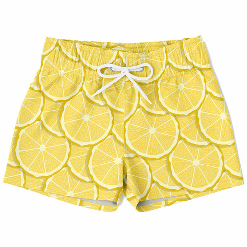 Boys lemon slice quick drying swim trunks in bright yellow with white drawstrings and a sliced lemon pattern