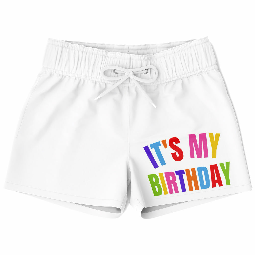 Boys white quick drying swim trunks with colorful its my birthday rainbow graphic printed on the front