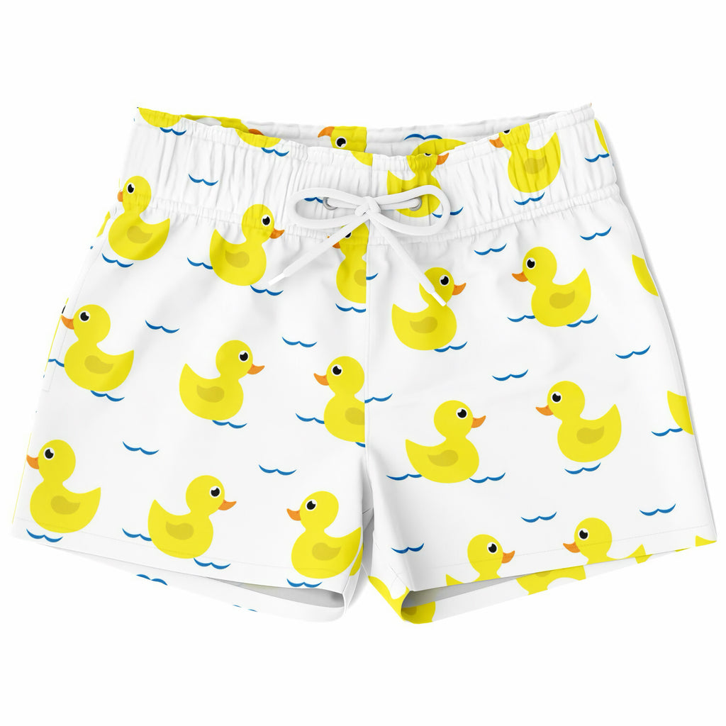 White boys swim trunks with quick drying fabric featuring yellow rubber ducks floating on blue water patterns