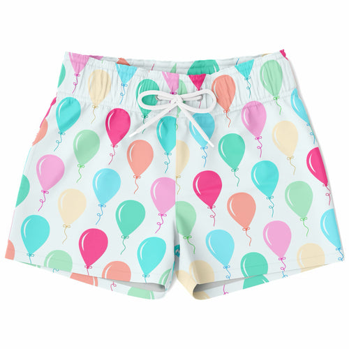 White boys quick drying swim trunks with colorful birthday balloon pattern in pink teal green and peach