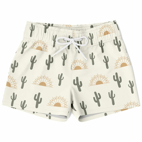 Cream-colored boys quick drying swim trunks with gray cactus and tan sunset pattern and white drawstrings