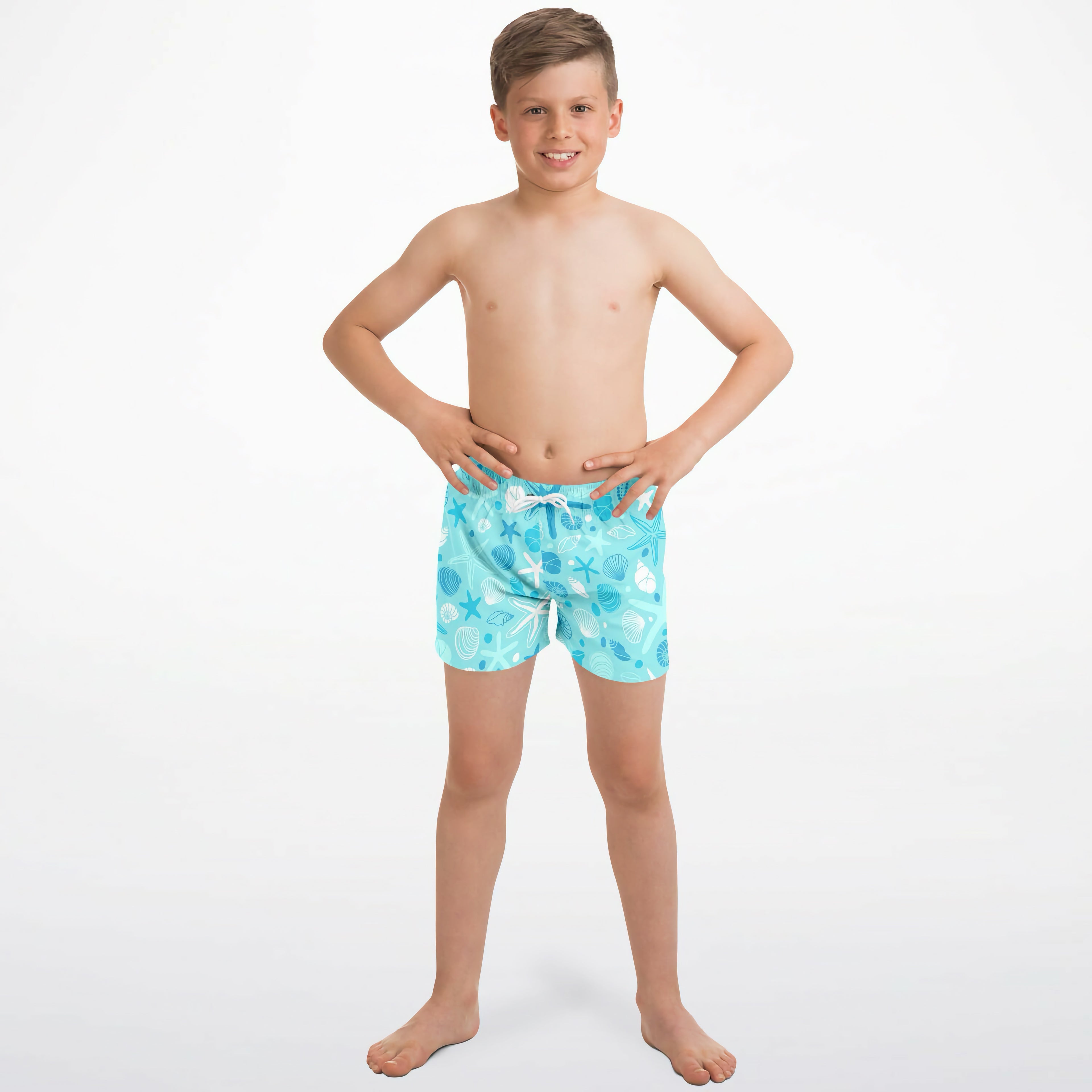 Light blue quick drying boys swim trunks with a playful white seashell starfish and seaweed pattern