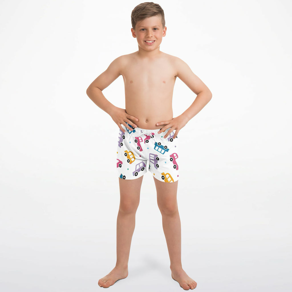 Boys colorful car quick drying swim trunks in white with a playful pattern of pink blue yellow and purple cars