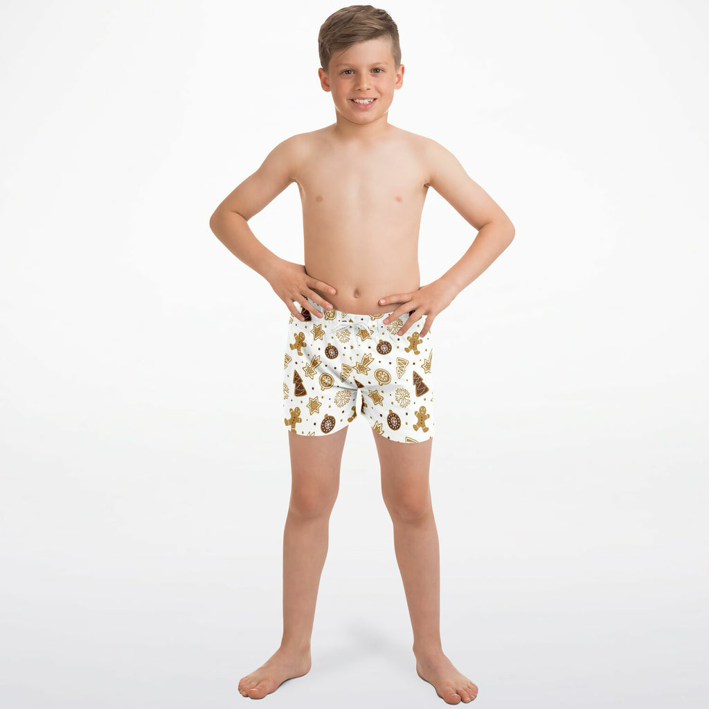 White boys quick drying swim trunks with playful brown gingerbread men and festive cookie pattern
