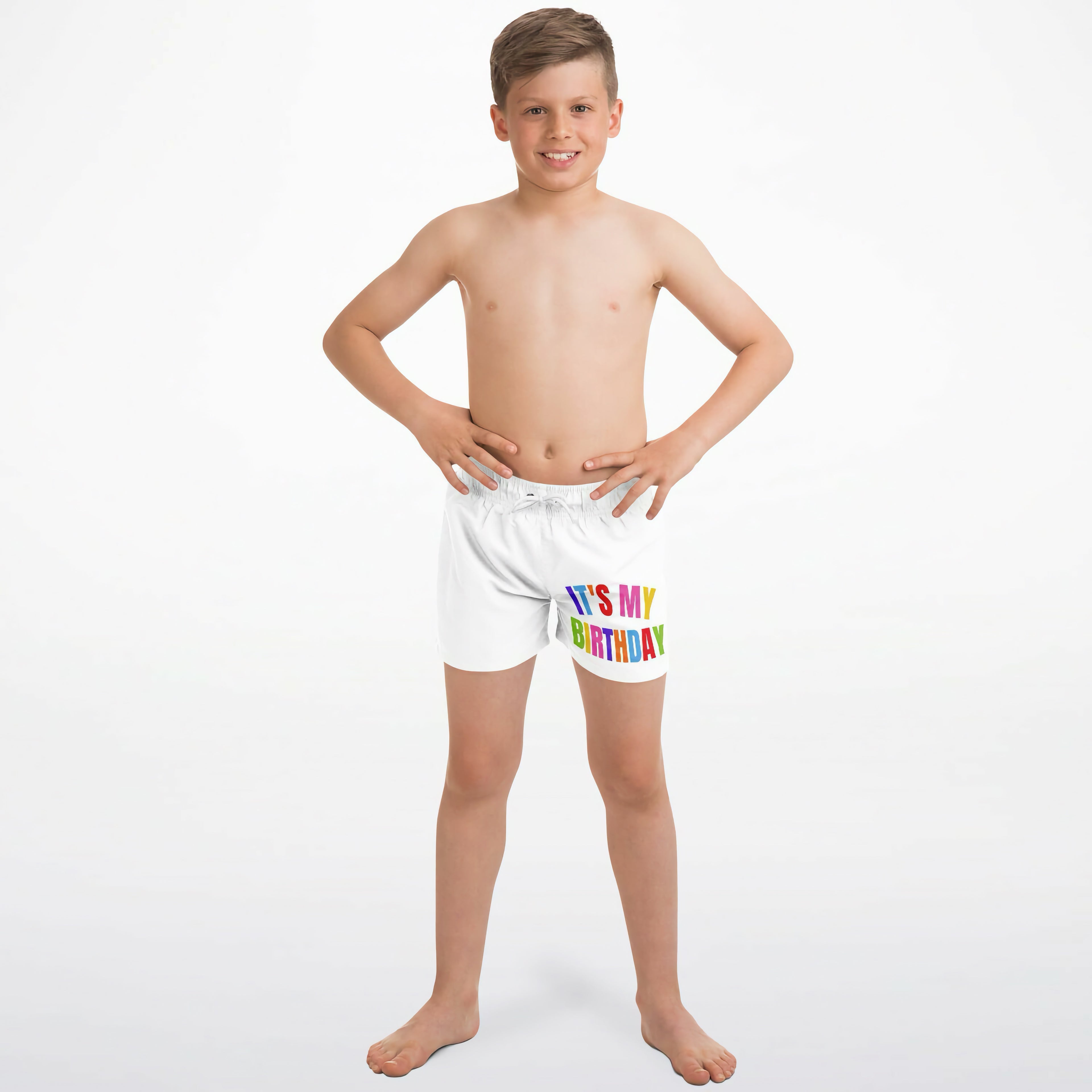 Boys white quick drying swim trunks with its my birthday printed in rainbow colors on the front