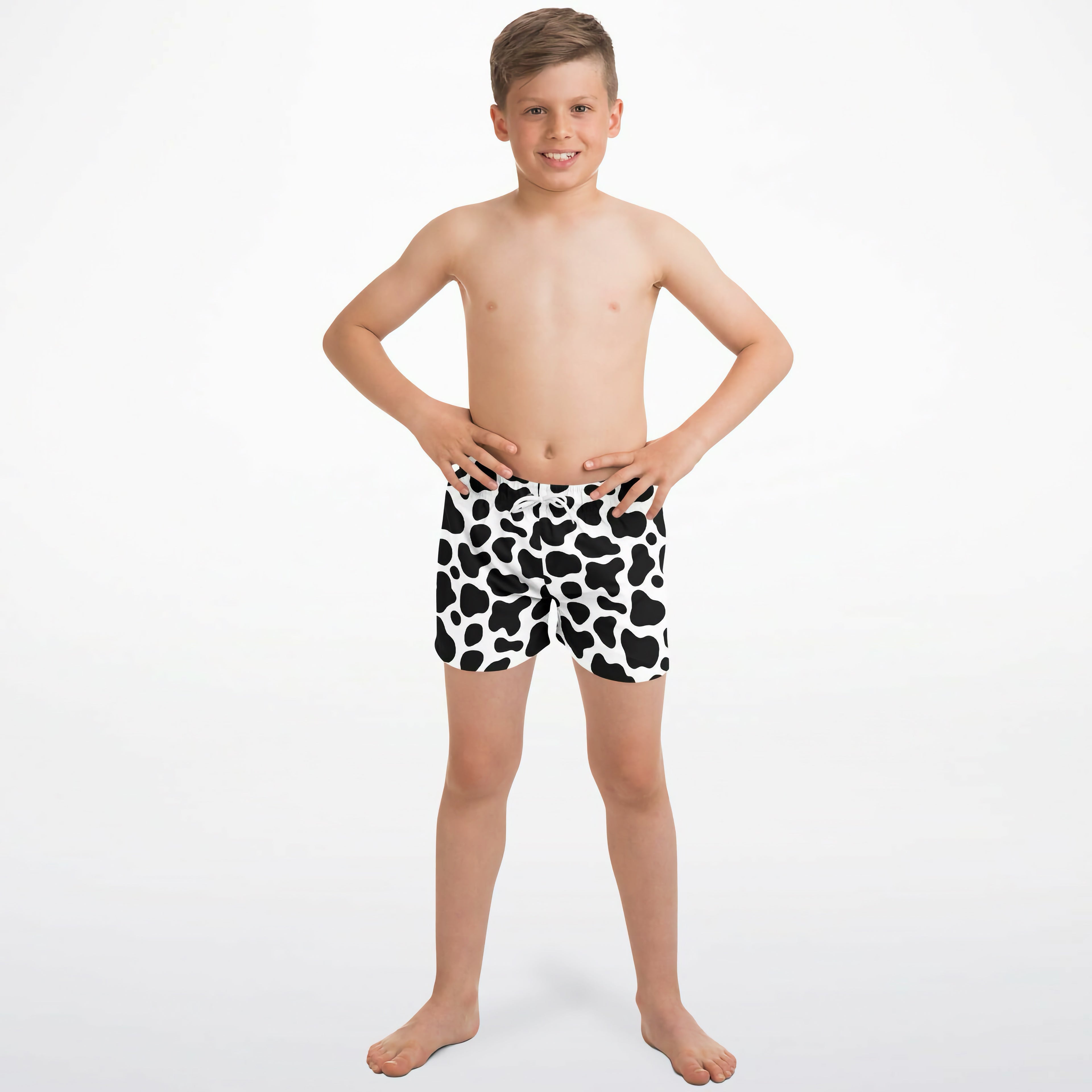 Boys cow print quick drying swim trunks in black and white with a quick dry fabric for swimming and beach use
