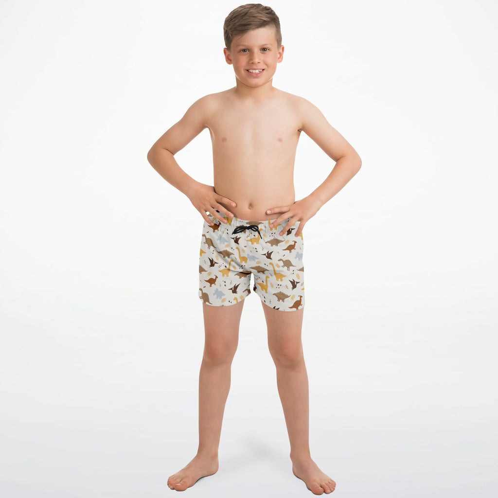 White boys dinosaur quick drying swim trunks with playful brown tan and gray dinosaur pattern