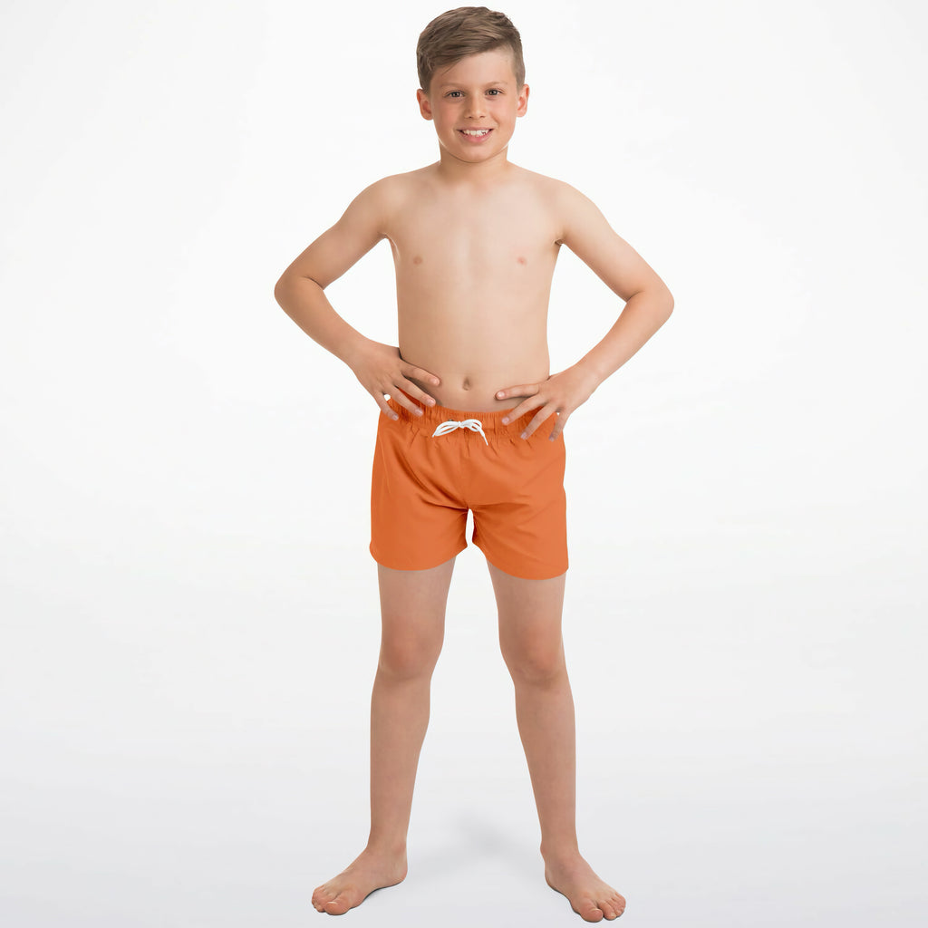 Boys orange quick drying swim trunks with bright orange fabric and a white drawstring waistband for swimming