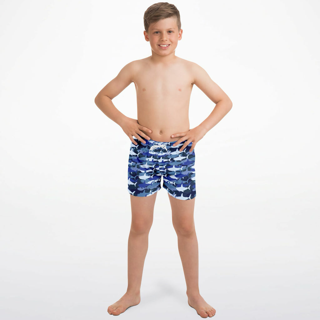 Boys blue shark quick drying swim trunks in blue with shark pattern and white drawstring for swimming activities