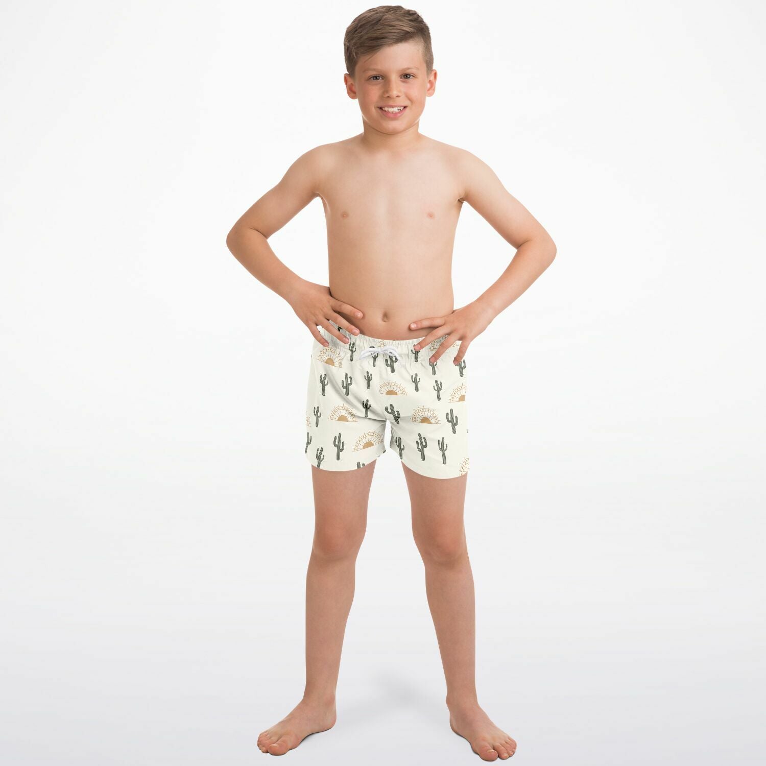 Boys cream-colored quick drying swim trunks with playful green cactus and golden sun pattern for desert sunrise theme