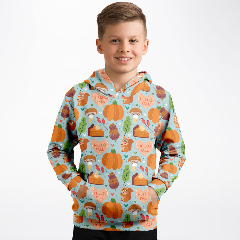A light blue kids hello fall hoodie with playful autumn pumpkins squirrels mushrooms and pie slices in cozy cotton fleece