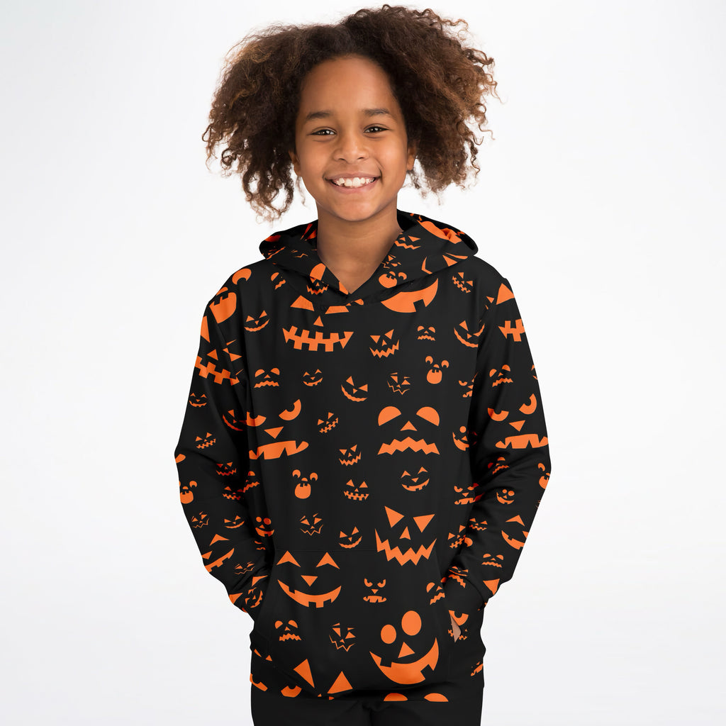 Kids orange jack-o-lantern halloween hoodie in black cotton fleece with orange pumpkin face patterns for cozy wear